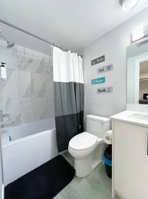 a bathroom with a toilet and a shower and a sink at Guest Suite in SouthWest Edmonton in Edmonton