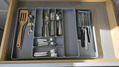 a tray of utensils sitting in a drawer at Luxury Basement Suite with 2 Bedrooms, 2 Queen Beds, Free Wi-Fi, and Free Parking in Calgary