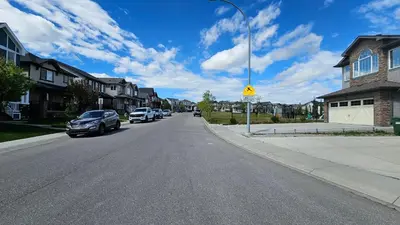 a street with cars parked on the side of the road at Luxury Basement Suite with 2 Bedrooms, 2 Queen Beds, Free Wi-Fi, and Free Parking in Calgary