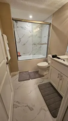 a bathroom with a toilet and a large window at Luxury Basement Suite with 2 Bedrooms, 2 Queen Beds, Free Wi-Fi, and Free Parking in Calgary