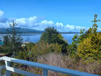 a view of a lake from a white fence at Cliff Haven on the Bay in Alert Bay
