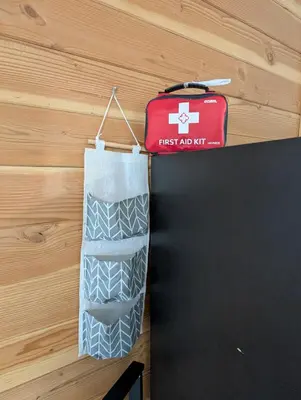 a first aid kit and a suitcase hanging on a wall at Gordie's Inn & Suites in Alert Bay