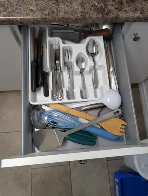 a drawer filled with utensils in a kitchen at Gordie's Inn & Suites in Alert Bay