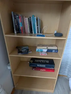 a book shelf filled with books and other books at Gordie's Inn & Suites in Alert Bay