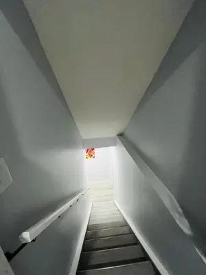 a stairway with a small window in a room at Amy's 2-Bedroom Residence in Calgary