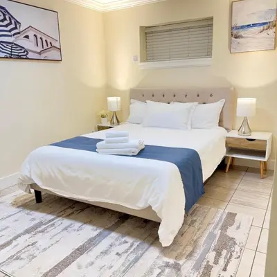 a bedroom with a large white bed with towels on it at Near Skytrain Metrotown Private Entry 3min walk to grocery food in Burnaby