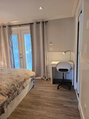 a bedroom with a desk and a bed and a desk and chair at Cozy home in Brookswood in Langley