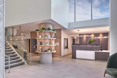 a lobby with a staircase and a reception area at Element by Westin Vancouver Metrotown in Burnaby