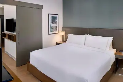 a bedroom with a large white bed and a television at Element by Westin Vancouver Metrotown in Burnaby