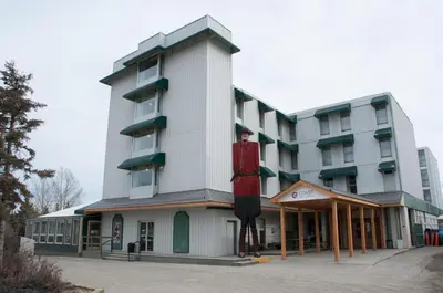 a building with a statue of a man on the side of it at Coast High Country Inn in Whitehorse