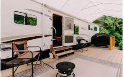 a white rv with chairs and a table in a room at Lower Meadow on Saltspring Island in Fernwood