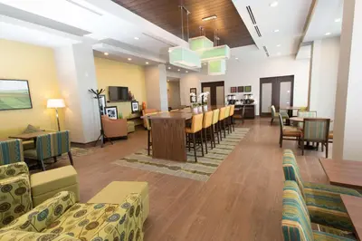 a dining room and living room with a dining table at Hampton Inn by Hilton Lloydminster in Lloydminster
