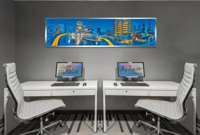 two desks with two computers on them in a room at Hotel Clique Calgary Airport in Calgary