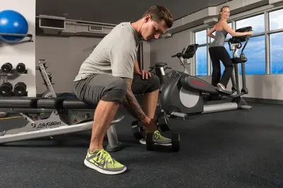 a man and a woman exercising on a treadmill in a gym at Hotel Clique Calgary Airport in Calgary