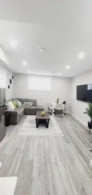 a living room with a couch and a table at fabulous and cozy guest suite in Calgary