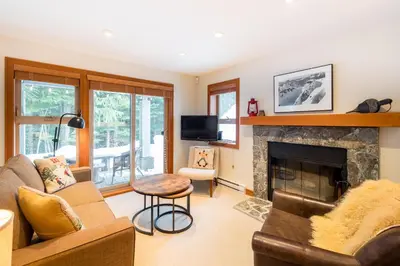 a living room with a couch and a fireplace at #24 Treeline in Whistler