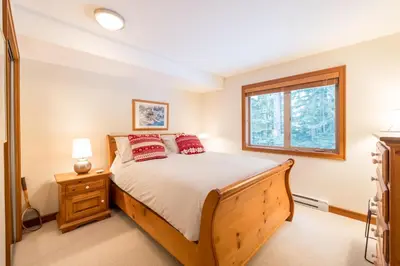 a bedroom with a bed and a window at #24 Treeline in Whistler
