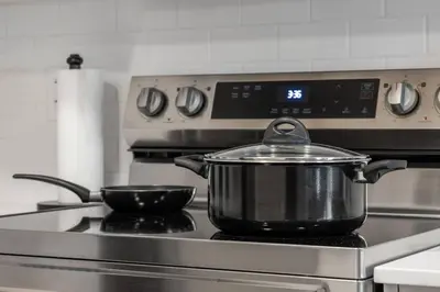 a pot sitting on top of a stove at Brand New Luxury Walk-out Suite - Calgary in Calgary