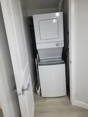 a small refrigerator in a room with a white door at Beautiful Comfy Guest Suite in West EDM in Edmonton