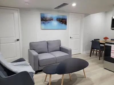 a living room with a couch and a table at Beautiful Comfy Guest Suite in West EDM in Edmonton