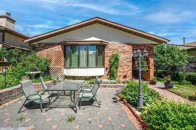 a patio with a table and chairs in front of a house at Nice 3 Bedroom 2 Bathroom Home Fenced yard near Downtown and YYC in Calgary