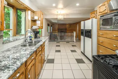 a kitchen with a sink and a refrigerator at Nice 3 Bedroom 2 Bathroom Home Fenced yard near Downtown and YYC in Calgary