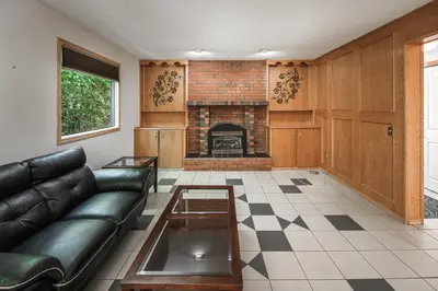 a living room with a couch and a fireplace at Nice 3 Bedroom 2 Bathroom Home Fenced yard near Downtown and YYC in Calgary