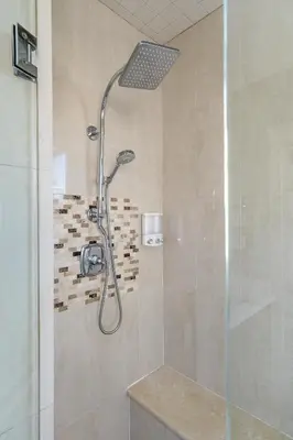 a shower with a shower head in a bathroom at Luxurious Multi-Family Home in Vancouver West, 10 Mins Downtown in Vancouver