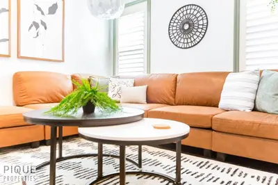 a living room with a couch and a table at Spacious Bright - Sleep 2 - Long Stays - NFLX&WIFI in Edmonton