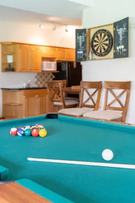 a kitchen with a pool table with balls on it at Chateau Lawrence, Pool Table, Kids' Gaming Room in Fairmont Hot Springs