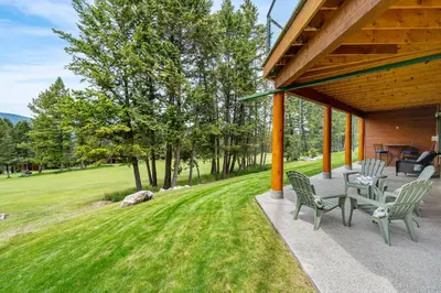 a patio with chairs and tables on a house at Chateau Lawrence, Pool Table, Kids' Gaming Room in Fairmont Hot Springs