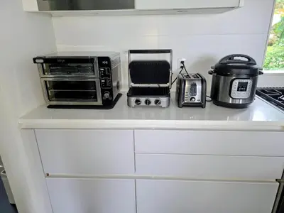 a kitchen counter with a toaster oven and a toaster at 2BD Guest Suite Sleeps 6 Near Downtown & Beach in West Vancouver
