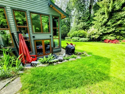 a garden with a house and a lawn with at 2BD Guest Suite Sleeps 6 Near Downtown & Beach in West Vancouver
