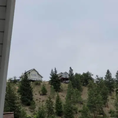 a group of houses on a hill with trees at La Casa Lakeside Resort - Amazing Panoramic View Lakeside House with Pools, Hot Tubs & More! in Kelowna