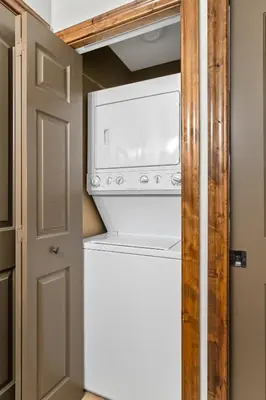 a washer and dryer in a small kitchen at Grizzly Springs, Outdoor Pool, Hot Tub, Fireplace in Radium Hot Springs