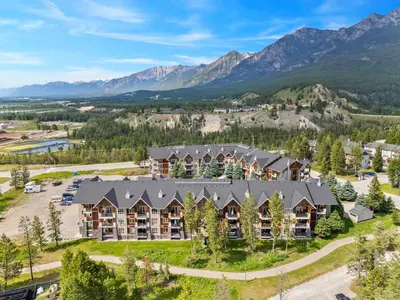 an aerial view of a resort with mountains in the background at Grizzly Springs, Outdoor Pool, Hot Tub, Fireplace in Radium Hot Springs