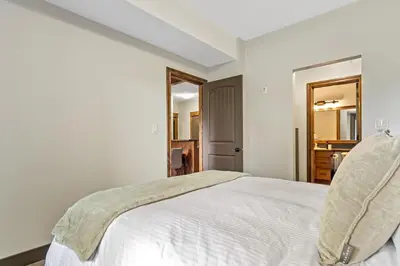 a bedroom with a large white bed in a room at Grizzly Springs, Outdoor Pool, Hot Tub, Fireplace in Radium Hot Springs