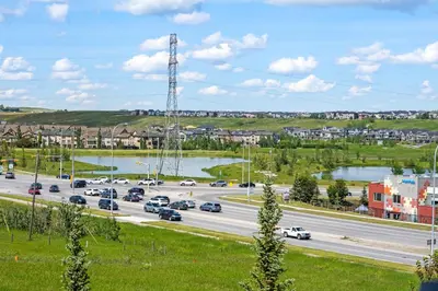 a highway with cars on it and a river at LUXURY LAKEVIEW HOME - 2500sqft of private space with 5 Beds, 4 Bath, 2 Living Rooms, Kitchen, AC, Jacuzzi, 10 Guests Max, Basement Not Included, 18-min to Airport, 20-min to Downtown, 80-min to Banff in Calgary