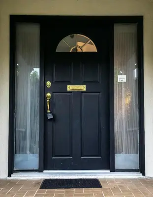 a black door with a gold sign on it at Cozy Guest Rooms Near UBC, Downtown and Beaches in Vancouver