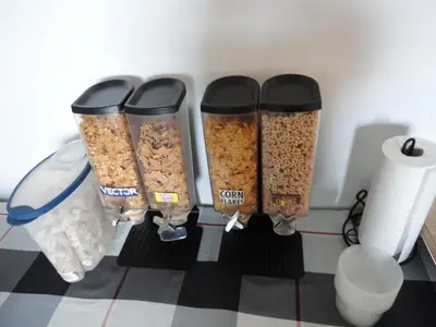 a group of four containers of granola on a wall at South Hill Motor Inn in Red Deer