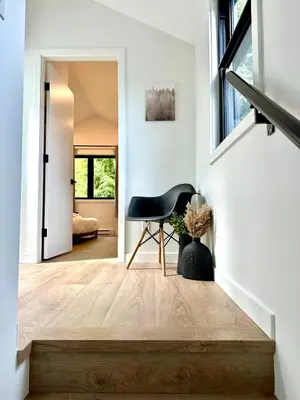 a hallway with a black chair in a house at cottage NOMAD in Ucluelet