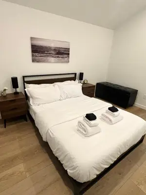 a bedroom with a bed with two towels on it at cottage NOMAD in Ucluelet