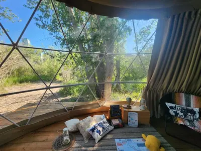 a room with a large window in a tent at D4 Badlands Bunker Dome- 1 Queen Pet Friendly in Drumheller