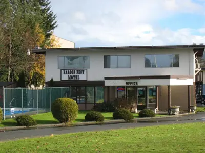 a building with a sign that reads final wait work at Falcon Nest Motel in Duncan
