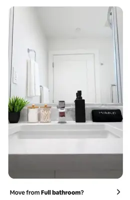 a bathroom with a white sink and a mirror at Cozy Private Suite near YVR Airport in Vancouver