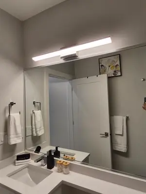 a bathroom with a sink and a large mirror at Cozy Private Suite near YVR Airport in Vancouver
