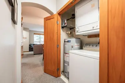 a kitchen with a stove and a refrigerator at Symphony by Outpost Whistler in Whistler
