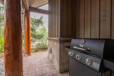an outdoor kitchen with a stove in a house at Symphony by Outpost Whistler in Whistler