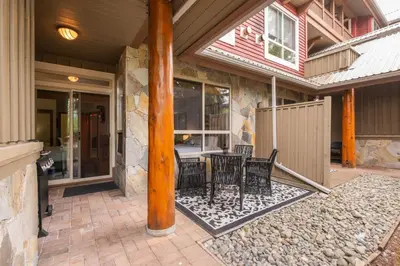 a porch of a house with a table and chairs at Symphony by Outpost Whistler in Whistler