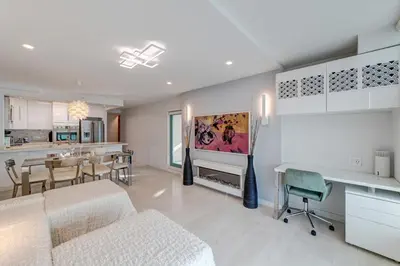 a living room with a kitchen and a dining room at Art Deco Broadway Queen Room in Vancouver